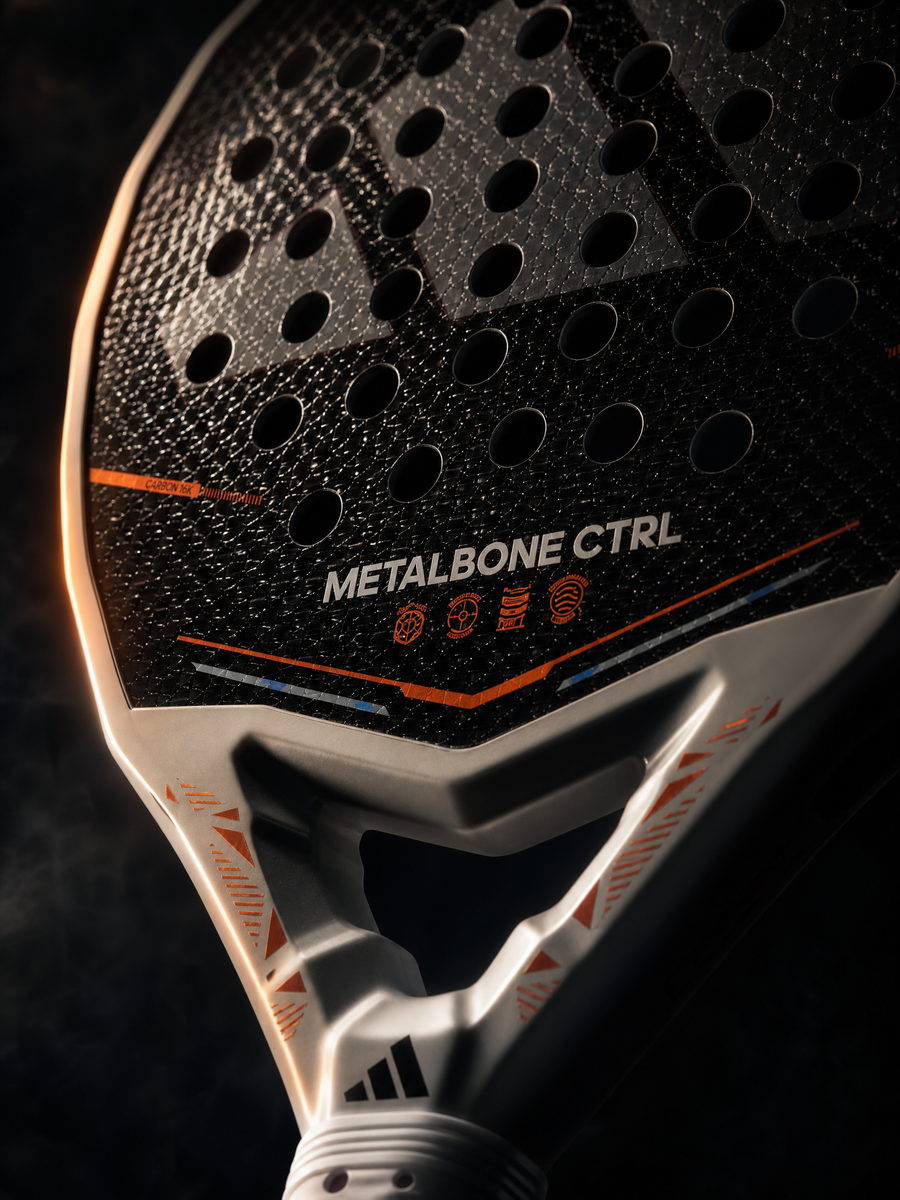 Close-up of a sports paddle with 'Metalbone Ctrl' branding on a dark background